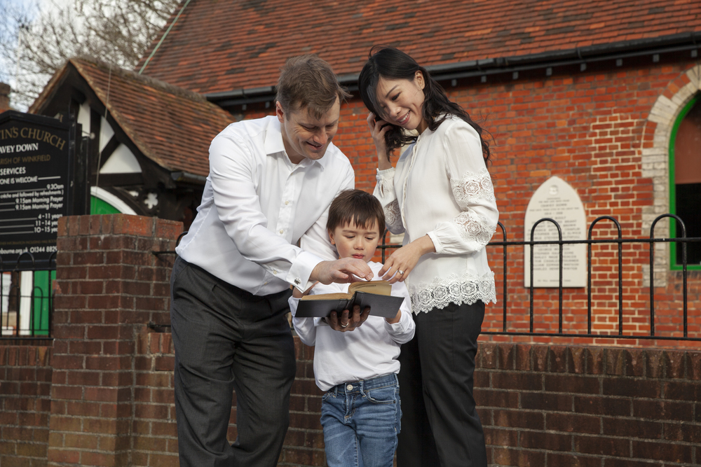 medium-shot-parents-kid-with-bible (1)